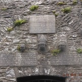 Three carved heads above the door