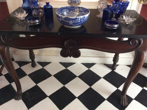 An Irish table stands of the tiled floor