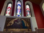 Lovely stained glass windows with mosaic memorial.