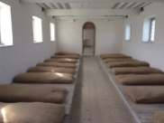 A dormitory, with straw beds. they may have had a blanket or rag to keep warm as they slept
